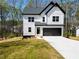 Charming two-story modern farmhouse with white siding, black trim, and a two-car garage at 101 Azalea Dr, Villa Rica, GA 30180