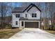 Charming two-story modern farmhouse with white siding, black trim, and a two-car garage at 101 Azalea Dr, Villa Rica, GA 30180