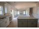 Kitchen featuring white cabinets, granite countertops, and an island overlooking the living space and stairs at 101 Azalea Dr, Villa Rica, GA 30180