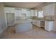 Bright kitchen featuring white cabinetry, granite countertops and a gray kitchen island at 101 Azalea Dr, Villa Rica, GA 30180