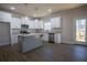 Bright kitchen features granite counters, stainless appliances, a gray island and access to the deck at 101 Azalea Dr, Villa Rica, GA 30180