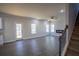 Living room with modern fireplace and staircase located off kitchen near backyard deck access at 101 Azalea Dr, Villa Rica, GA 30180