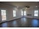 Bright living room with wood floors, ceiling fan, and access to outdoor deck with wooded view at 101 Azalea Dr, Villa Rica, GA 30180