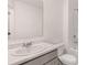 Clean bathroom with white vanity and marble countertop, plus a tub at 989 Cades Walk, Lawrenceville, GA 30045