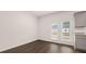 Dining area with access to the deck, featuring dark floors and neutral paint at 989 Cades Walk, Lawrenceville, GA 30045