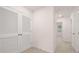 Hallway with linen closet and view into carpeted room with window at 989 Cades Walk, Lawrenceville, GA 30045
