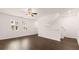Open living room with dark floors, ceiling fan, and lots of natural light at 989 Cades Walk, Lawrenceville, GA 30045