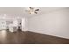 Open-concept living space with kitchen, living room, and dining area, featuring wood floors at 989 Cades Walk, Lawrenceville, GA 30045