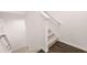 Carpeted staircase showcasing a white railing, white risers and wood flooring at 989 Cades Walk, Lawrenceville, GA 30045