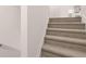 Carpeted stairs with white trim add comfort at 989 Cades Walk, Lawrenceville, GA 30045
