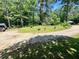 A spacious lot with potential, partially wooded with a circular driveway and mature trees at 202 Hayes St, Villa Rica, GA 30180
