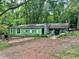 Charming single-Gathering home with an inviting covered porch set on a spacious lot surrounded by lush greenery at 202 Hayes St, Villa Rica, GA 30180