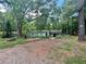 Quaint single-story home with a covered porch nestled among mature trees in a private, wooded lot at 202 Hayes St, Villa Rica, GA 30180