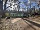 Cozy one-story house with a screened front porch, set on a large, tree-filled lot with potential at 202 Hayes St, Villa Rica, GA 30180