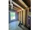 Interior view of a room under construction, featuring exposed framing, a window, and tile floors at 202 Hayes St, Villa Rica, GA 30180