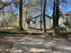 House backyard with a long driveway and trees at 880 Cascade Sw Rd, Atlanta, GA 30311