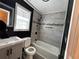 Updated bathroom with gray tile and bathtub at 880 Cascade Sw Rd, Atlanta, GA 30311