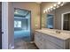 Bathroom with a white vanity, mirror, and doorway leading to the main bedroom at 3634 Autumn Ridge Pkwy, Marietta, GA 30066