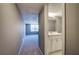 Hallway leading into a bathroom with a white vanity and neutral tones at 3634 Autumn Ridge Pkwy, Marietta, GA 30066