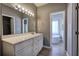 Bathroom with a white vanity, mirror, and doorway leading to tub and shower at 3634 Autumn Ridge Pkwy, Marietta, GA 30066