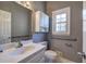 Bathroom featuring white vanity, sink, toilet, grab bars, and large mirror at 3634 Autumn Ridge Pkwy, Marietta, GA 30066