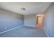 Spacious carpeted bedroom with a neutral color palette, featuring an electrical outlet and access to an entry door at 3634 Autumn Ridge Pkwy, Marietta, GA 30066