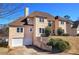 Two-story stucco home boasts a 2-car garage and meticulously landscaped yard, near a serene lake, under a clear blue sky at 3634 Autumn Ridge Pkwy, Marietta, GA 30066