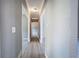 Hallway with gray walls and white trim provides access to other rooms and a view down the length of the hall at 3634 Autumn Ridge Pkwy, Marietta, GA 30066