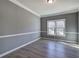 Bright living room with gray walls, white trim, and wood-look flooring is naturally lit by double hung windows at 3634 Autumn Ridge Pkwy, Marietta, GA 30066