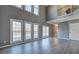 Spacious living room featuring new floors, fresh paint, three large windows and back staircase at 3634 Autumn Ridge Pkwy, Marietta, GA 30066