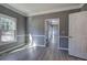 Living room features gray walls, white trim, wood-look flooring, and windows overlooking a natural setting at 3634 Autumn Ridge Pkwy, Marietta, GA 30066