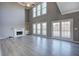 Spacious living room with a fireplace, built in shelves, hardwood floors and three large windows at 3634 Autumn Ridge Pkwy, Marietta, GA 30066