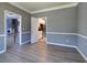 Spacious living room has wood-look flooring and an open doorway to the kitchen and staircase to the second floor at 3634 Autumn Ridge Pkwy, Marietta, GA 30066