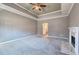 Expansive main bedroom with tray ceiling, gray walls, fireplace, and carpeting offers a relaxing retreat at 3634 Autumn Ridge Pkwy, Marietta, GA 30066