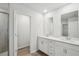 Bright bathroom with dual sinks, white cabinetry, and modern fixtures, offering style and functionality at 1220 Firefly Field Trce, Lawrenceville, GA 30045