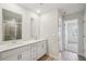 Bright bathroom with double vanity, quartz countertop, and access to the shower room and closet at 1230 Firefly Field Trce, Lawrenceville, GA 30045