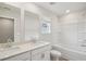 A full bathroom offers double sinks, generous counter space, and a shower and tub combo at 1230 Firefly Field Trce, Lawrenceville, GA 30045