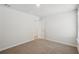 A bedroom features neutral walls, plush carpet, and a doorway leading to an additional room at 1230 Firefly Field Trce, Lawrenceville, GA 30045