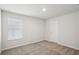 Clean and bright bedroom with plush carpeting, a window, and white walls, creating a serene and inviting space at 1230 Firefly Field Trce, Lawrenceville, GA 30045