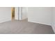 Expansive bedroom space with neutral carpeting and a doorway leading to another room or hallway at 1230 Firefly Field Trce, Lawrenceville, GA 30045