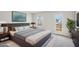 Comfortable bedroom featuring a large bed, stylish decor, and ample natural light from the window and access to a balcony at 1230 Firefly Field Trce, Lawrenceville, GA 30045