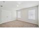 Well-lit bedroom with neutral carpeting, double closets, and two windows providing ample natural light at 1230 Firefly Field Trce, Lawrenceville, GA 30045