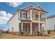 Elegant two-story home showcasing a mix of brick and siding, with a charming balcony at 1230 Firefly Field Trce, Lawrenceville, GA 30045