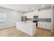 The kitchen boasts a center island, stainless steel appliances, and white cabinetry at 1230 Firefly Field Trce, Lawrenceville, GA 30045