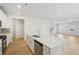 Open kitchen with island featuring stainless steel appliances, and modern fixtures at 1230 Firefly Field Trce, Lawrenceville, GA 30045