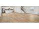 Bright, open floorplan showing wood-look floors, updated kitchen, and staircase access at 1230 Firefly Field Trce, Lawrenceville, GA 30045