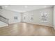Bright living room featuring beautiful floors, recessed lighting, and multiple windows at 1230 Firefly Field Trce, Lawrenceville, GA 30045