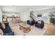 Staged living room boasts modern furniture, a cozy rug, and an open floorplan at 1230 Firefly Field Trce, Lawrenceville, GA 30045