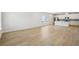 Spacious living area with modern flooring and light paint adjacent to a well-lit kitchen at 1230 Firefly Field Trce, Lawrenceville, GA 30045