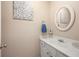 Charming bathroom features a white vanity, round mirror, and decorative wall art at 1101 Collier Nw Rd # V6, Atlanta, GA 30318